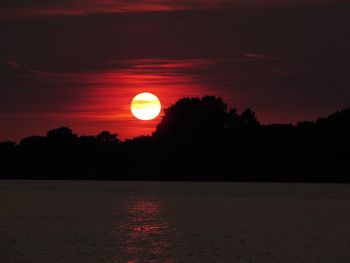 Scenic view of silhouette trees against sky during sunset