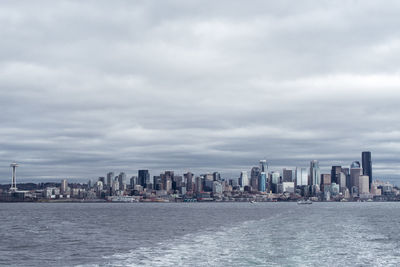 Sea and cityscape against sky