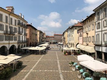Street amidst buildings in town against sky