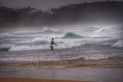 People surfing in sea