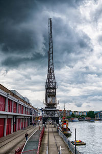 Tower bridge in city against cloudy sky