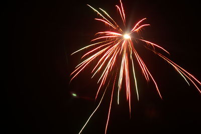 Low angle view of firework display at night