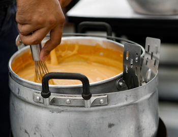 Close-up of person preparing food in kitchen
