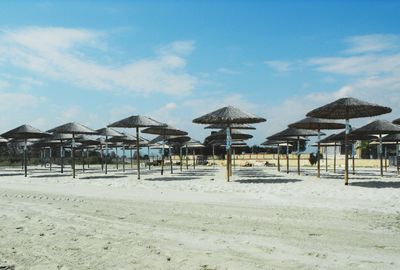Lifeguard hut on beach against sky