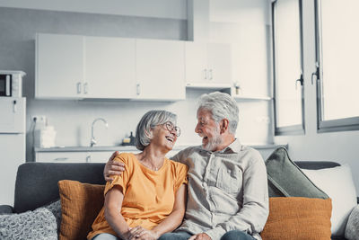 Side view of senior man sitting at home