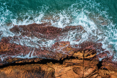 High angle view of rocks by sea