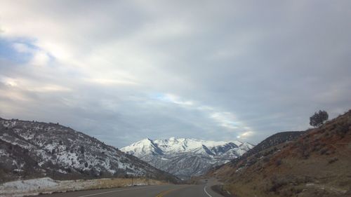 View of snowcapped mountain against cloudy sky