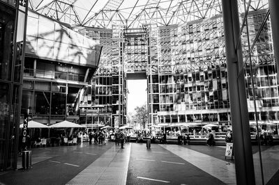 People on street amidst buildings in city