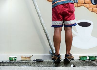 Low section of woman standing on tiled floor