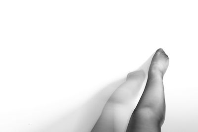 Low section of woman against white background