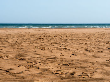 Scenic view of beach against clear sky