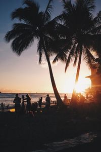 Silhouette of people at beach during sunset