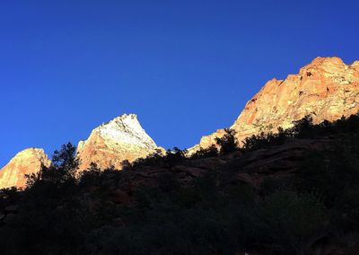 Scenic view of mountains against clear blue sky