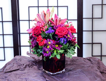 Close-up of pink flower vase on table
