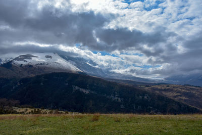 Scenic view of landscape and mountains against sky