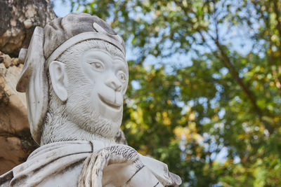 Low angle view of statue against trees