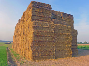 Stone wall on field against sky