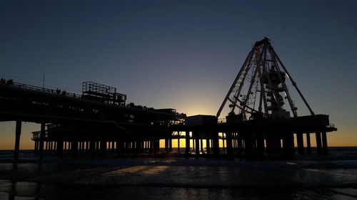 Bridge against clear blue sky during sunset