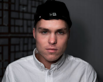 Portrait of young man against black background