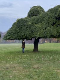 Rear view of man standing on land against sky