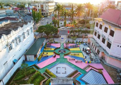 High angle view of swimming pool by buildings in city