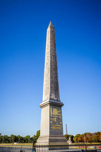 Low angle view of monument against blue sky