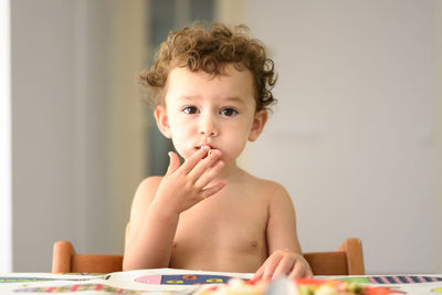 Portrait of boy sitting on table