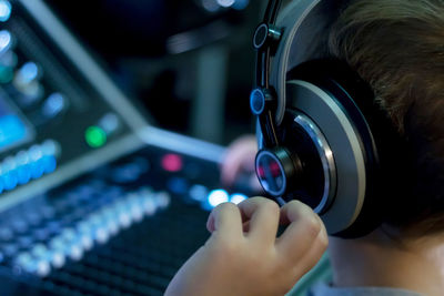 Close-up of boy using sound mixer in studio