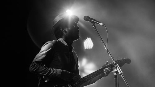 Low angle view of singer with guitar during music concert