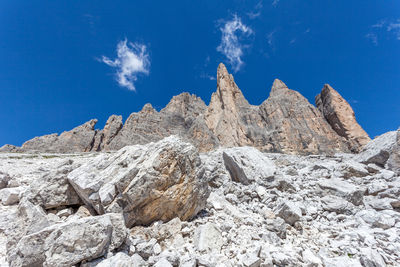 Low angle view of rock formations against blue sky