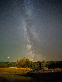 Scenic view of field against sky at night