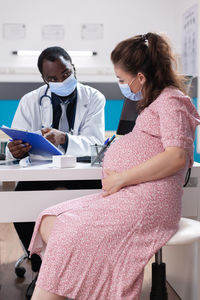 Female doctor examining patient at clinic