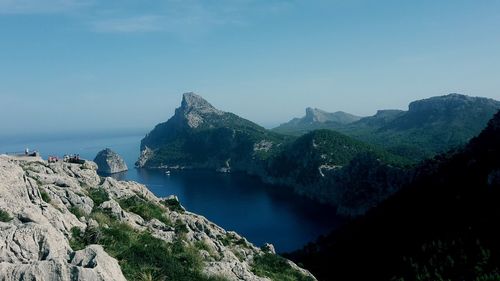 Scenic view of sea and mountains against sky