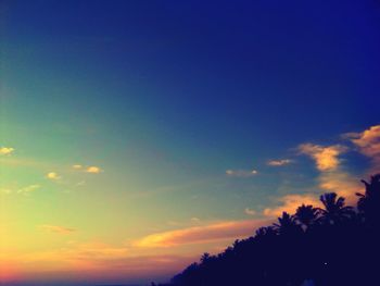 Low angle view of silhouette trees against romantic sky