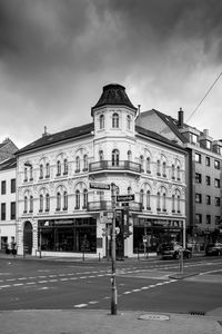 Street by building in city against sky