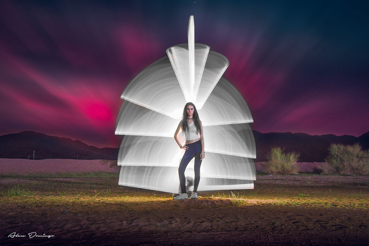 full length, one person, sky, standing, real people, nature, leisure activity, lifestyles, illuminated, cloud - sky, field, long exposure, front view, land, adult, beauty in nature, night, women, casual clothing