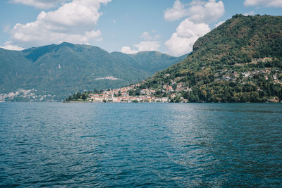 Scenic view of sea and mountains against sky