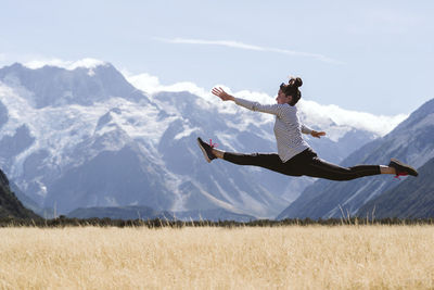 Person paragliding against mountain range