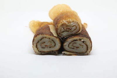 Close-up of bread over white background
