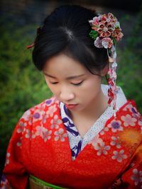 Close-up of girl with red flowers
