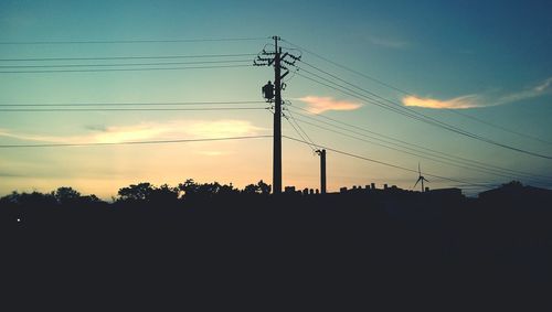 Low angle view of electricity pylon against sky