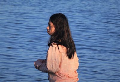 Rear view of woman standing in water