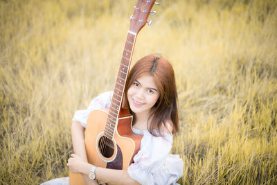 Portrait of a smiling young woman on field