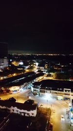 Aerial view of city lit up at night