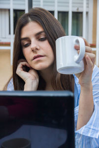 Portrait of woman drinking coffee cup