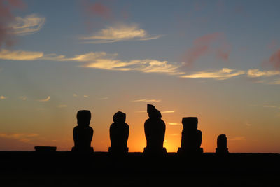 Silhouette statue against sky during sunset