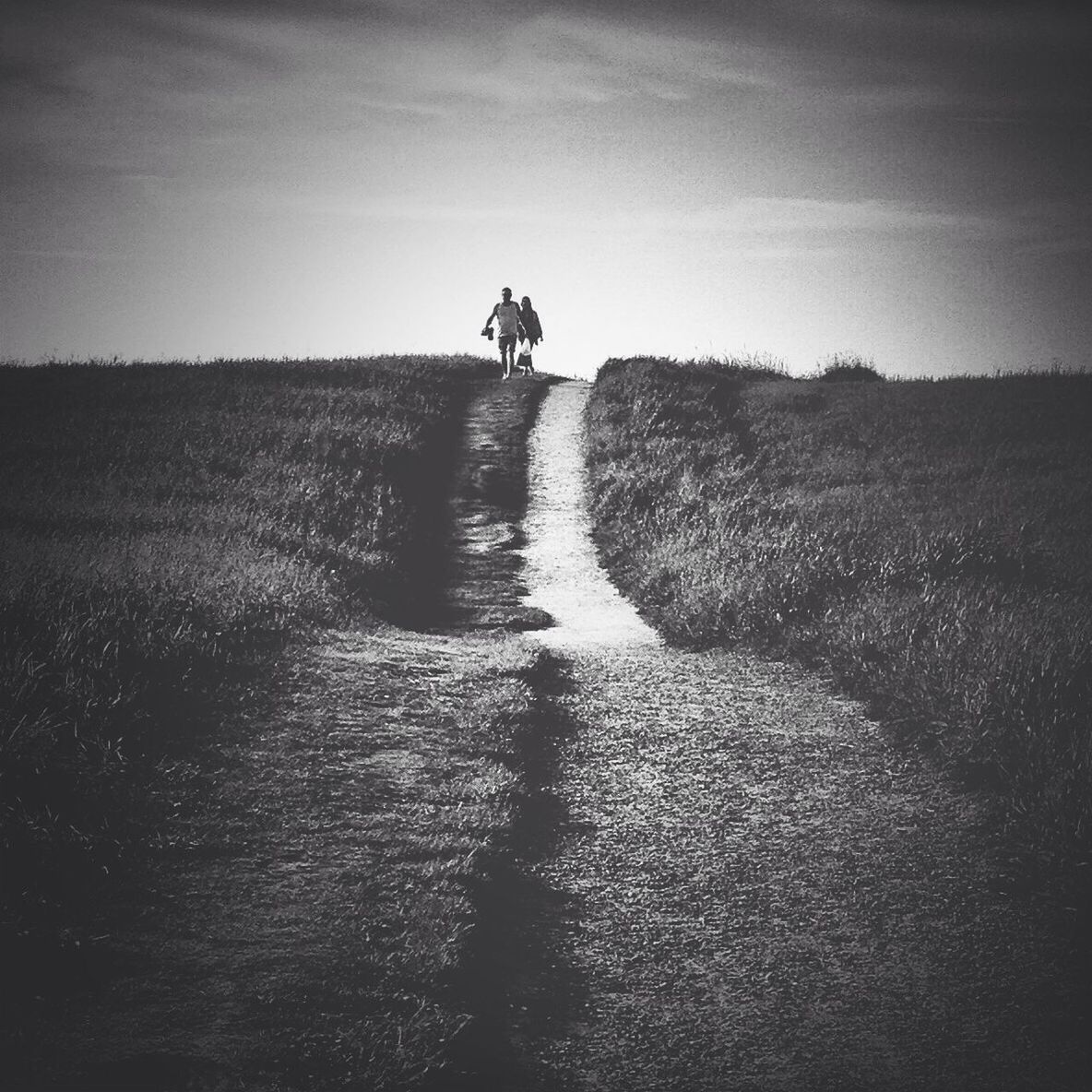 lifestyles, leisure activity, full length, men, walking, sky, rear view, landscape, standing, silhouette, tranquility, tranquil scene, nature, field, person, sunlight, scenics