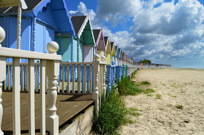 Row of beach huts against sky