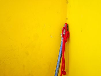 Close-up of metal against yellow wall