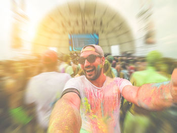 Portrait of man in sunglasses covered with powder paints